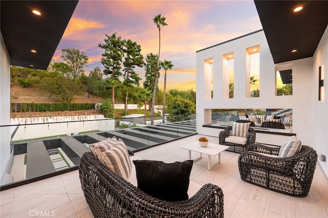 balcony at dusk with outdoor lounge area