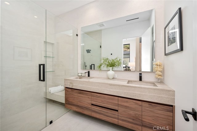 bathroom featuring tasteful backsplash, a shower with door, vanity, and tile patterned flooring