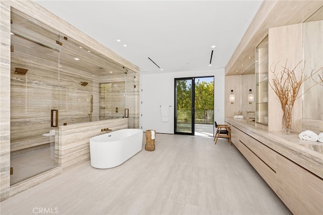 bathroom with shower with separate bathtub, vanity, and hardwood / wood-style flooring