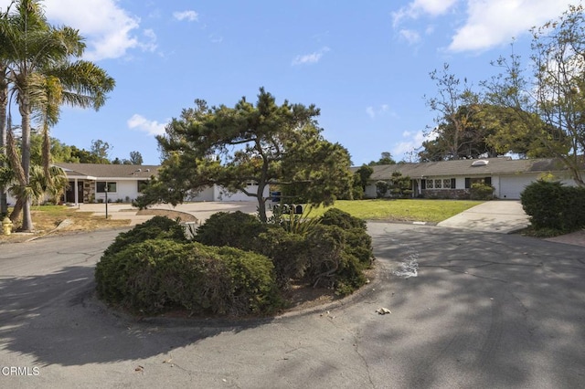 single story home featuring a front yard and a garage