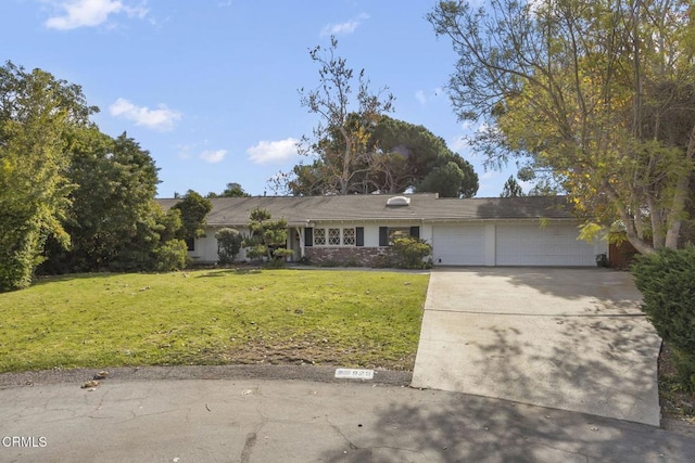 ranch-style home with a front yard and a garage