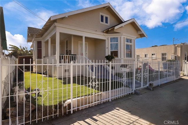 view of front of home featuring covered porch and a front yard