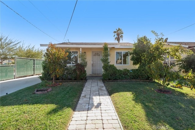 bungalow-style home with a front lawn