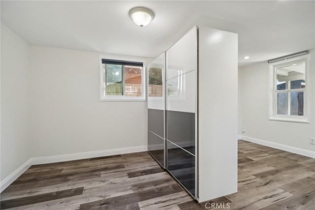 spare room featuring wood-type flooring