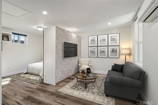 living room with hardwood / wood-style floors and a wall mounted AC