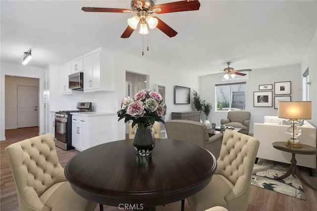 dining room featuring ceiling fan and dark hardwood / wood-style flooring