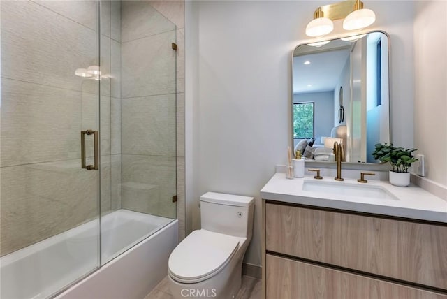 full bathroom with vanity, toilet, and enclosed tub / shower combo