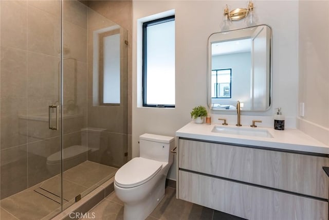 bathroom featuring tile patterned floors, vanity, toilet, and walk in shower