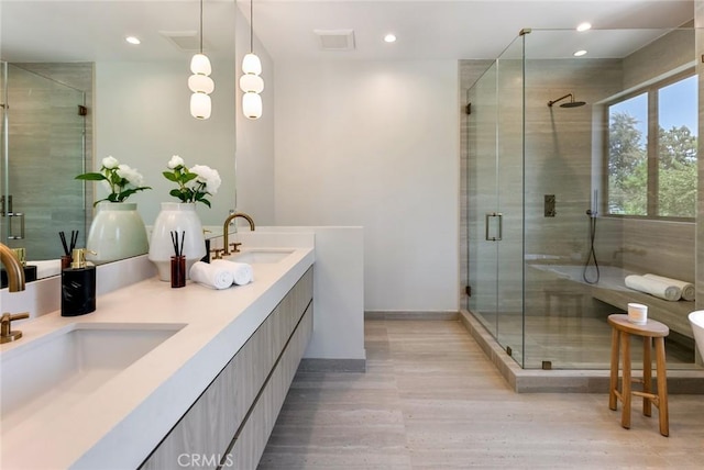 bathroom featuring hardwood / wood-style floors, vanity, and walk in shower