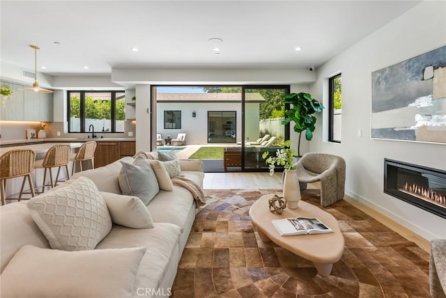 living room featuring hardwood / wood-style floors and sink