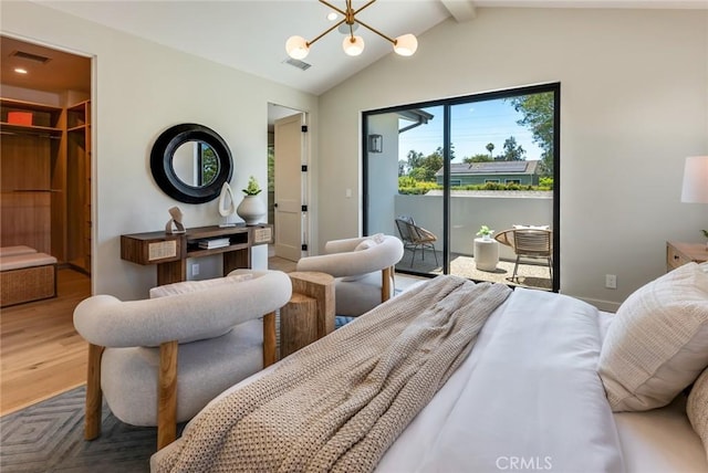 bedroom featuring hardwood / wood-style floors, lofted ceiling with beams, a spacious closet, a notable chandelier, and a closet