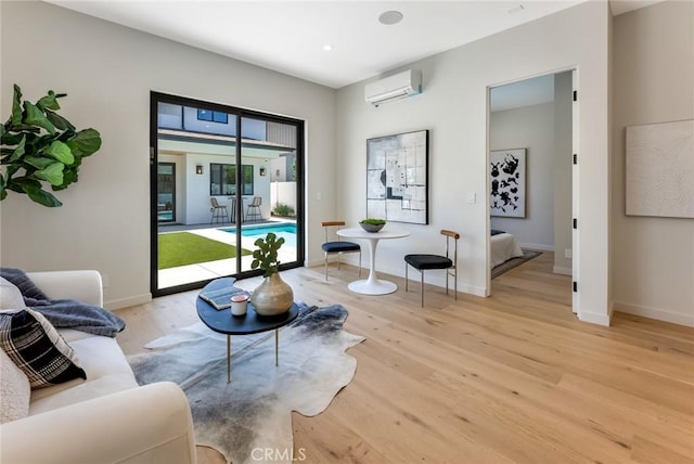 living room with light hardwood / wood-style flooring and a wall mounted AC