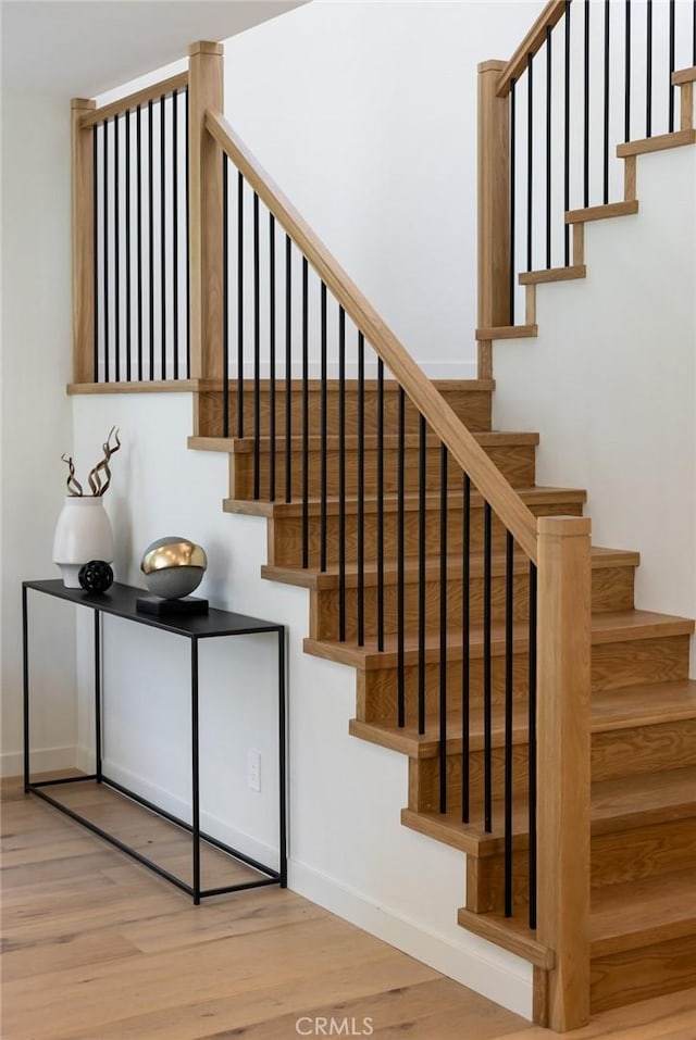 stairway featuring hardwood / wood-style floors