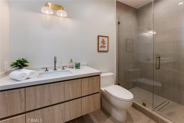 bathroom featuring tile patterned flooring, vanity, an enclosed shower, and toilet