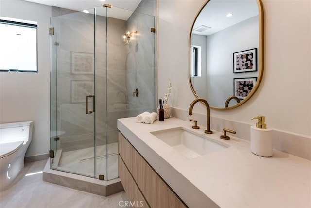 bathroom with a shower with door, vanity, and toilet