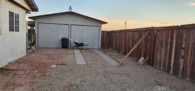 outdoor structure at dusk featuring a garage