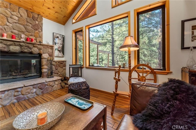 sitting room featuring a fireplace, hardwood / wood-style flooring, vaulted ceiling, and wood ceiling