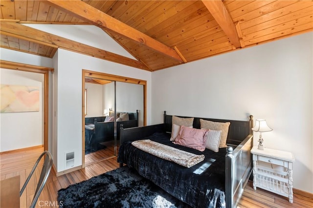 bedroom featuring wood ceiling, vaulted ceiling with beams, a closet, and wood-type flooring