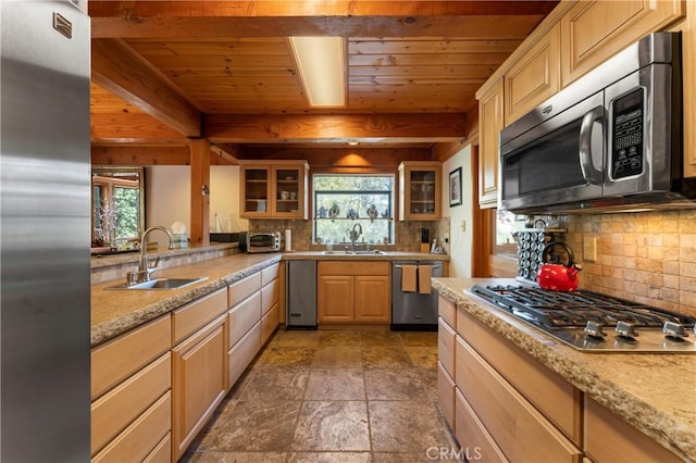 kitchen featuring backsplash, light brown cabinets, sink, and appliances with stainless steel finishes