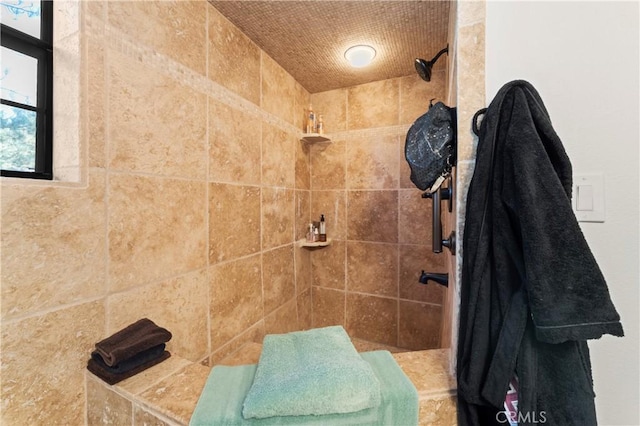 bathroom with tiled shower