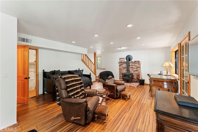 living room featuring hardwood / wood-style flooring and a wood stove