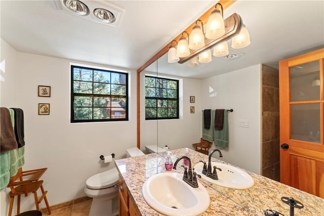 bathroom featuring tile patterned floors, vanity, and toilet