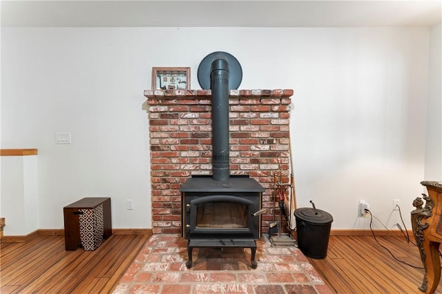 interior details with hardwood / wood-style floors and a wood stove