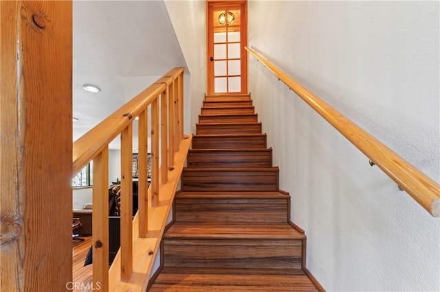 staircase with hardwood / wood-style floors