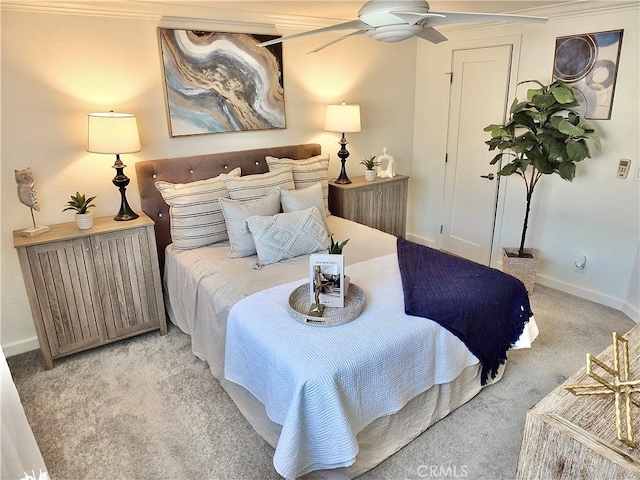 bedroom featuring light colored carpet, ceiling fan, and crown molding