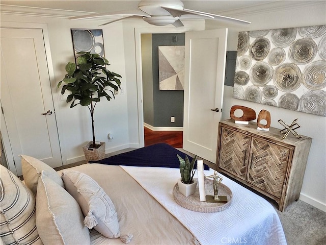 bedroom with ceiling fan and crown molding