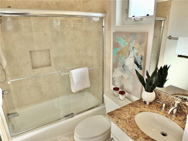 full bathroom with toilet, vanity, and combined bath / shower with glass door