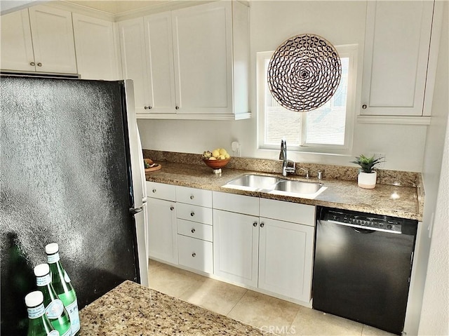 kitchen with sink, light tile patterned floors, dishwasher, white cabinetry, and fridge