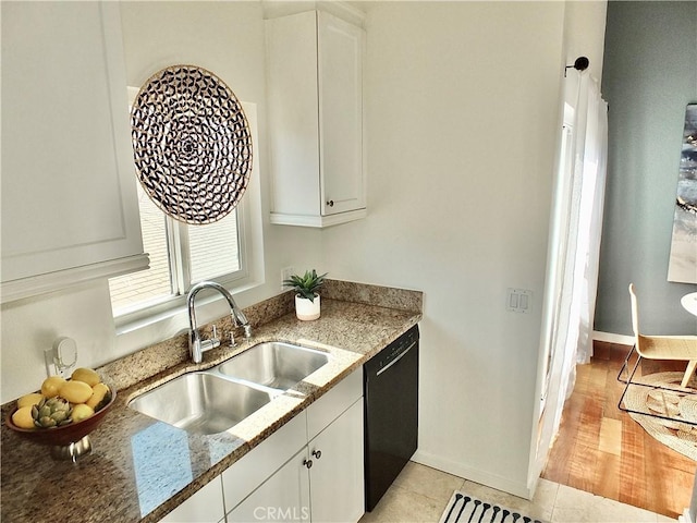 kitchen featuring sink, white cabinets, stone countertops, and black dishwasher