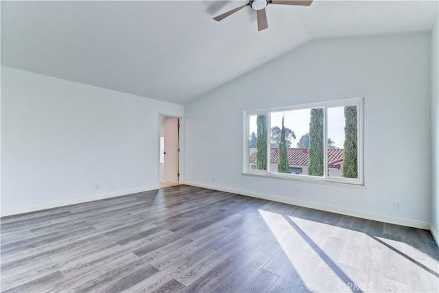 spare room with ceiling fan, vaulted ceiling, and hardwood / wood-style flooring