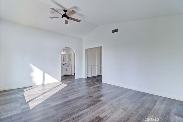 spare room featuring ceiling fan, dark hardwood / wood-style flooring, and lofted ceiling