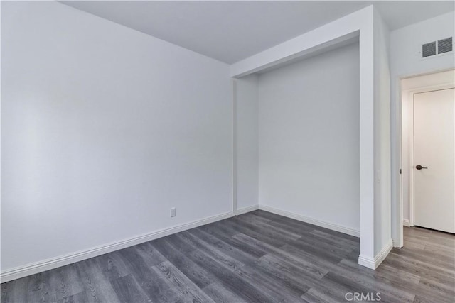 unfurnished room featuring dark hardwood / wood-style floors