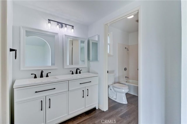 full bathroom with toilet, vanity, tub / shower combination, and hardwood / wood-style flooring