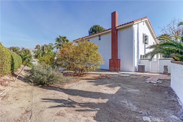 view of side of property with central AC unit