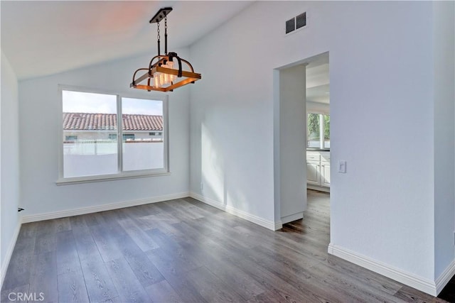 unfurnished dining area with vaulted ceiling and dark hardwood / wood-style flooring