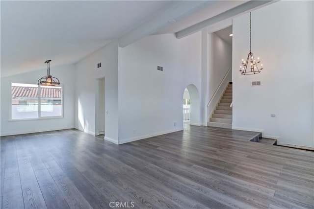 unfurnished room featuring vaulted ceiling with beams, dark hardwood / wood-style flooring, and an inviting chandelier