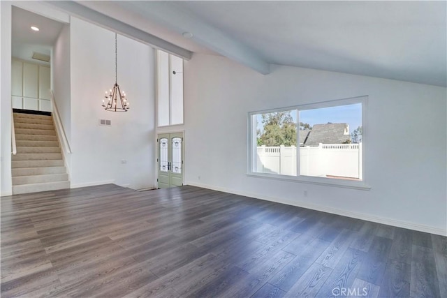 unfurnished living room with dark wood-type flooring, an inviting chandelier, and vaulted ceiling with beams