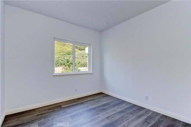 spare room with dark hardwood / wood-style floors