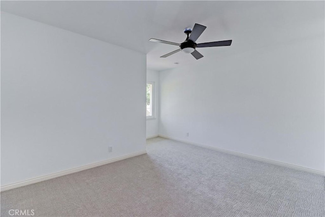 unfurnished room featuring ceiling fan and light colored carpet