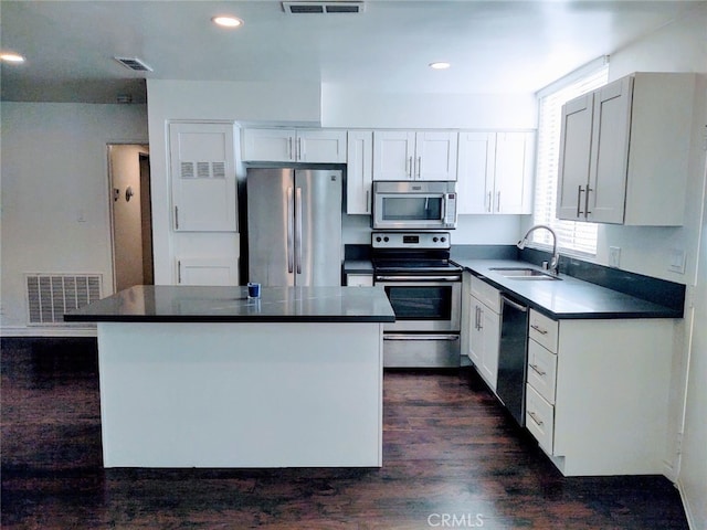 kitchen with white cabinets, sink, a kitchen island, and stainless steel appliances