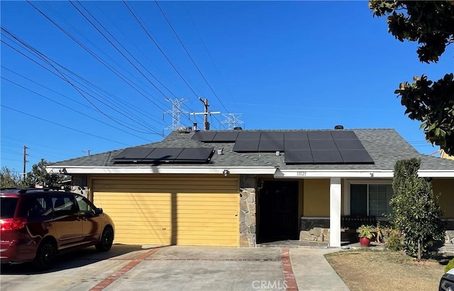 view of front of home featuring solar panels and a porch