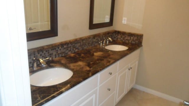 bathroom featuring tile patterned flooring and vanity