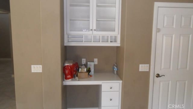 bar featuring white cabinets