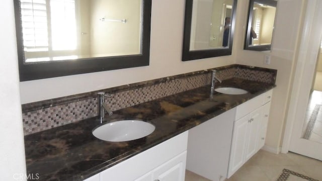 bathroom with tile patterned floors and vanity