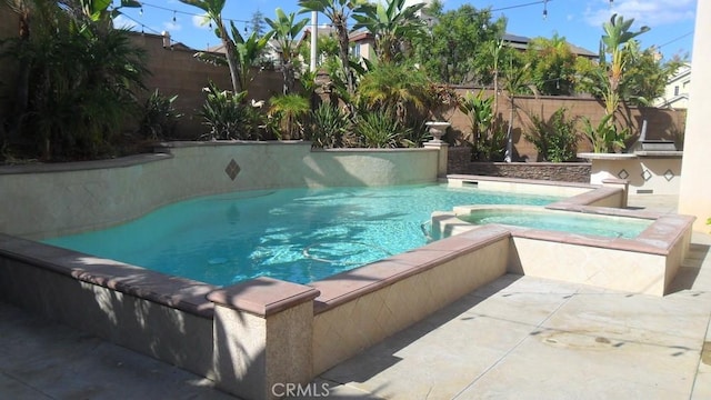 view of swimming pool featuring an in ground hot tub