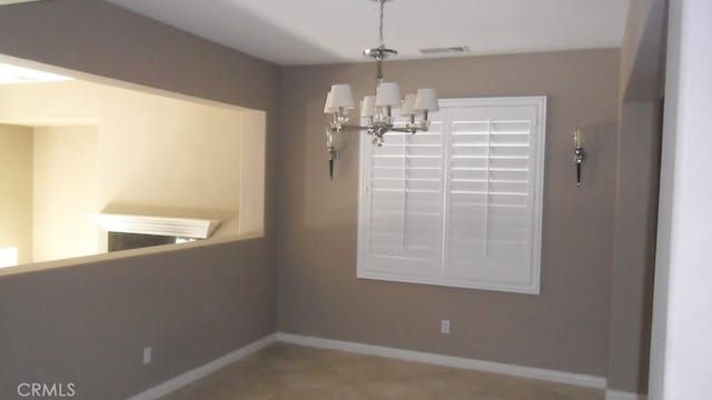 unfurnished dining area with an inviting chandelier